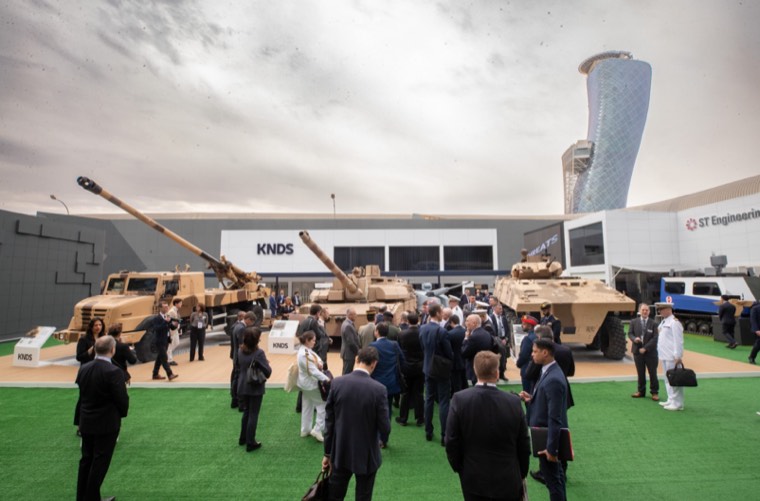Visitors gathering around armoured vehicles in the outdoor display area