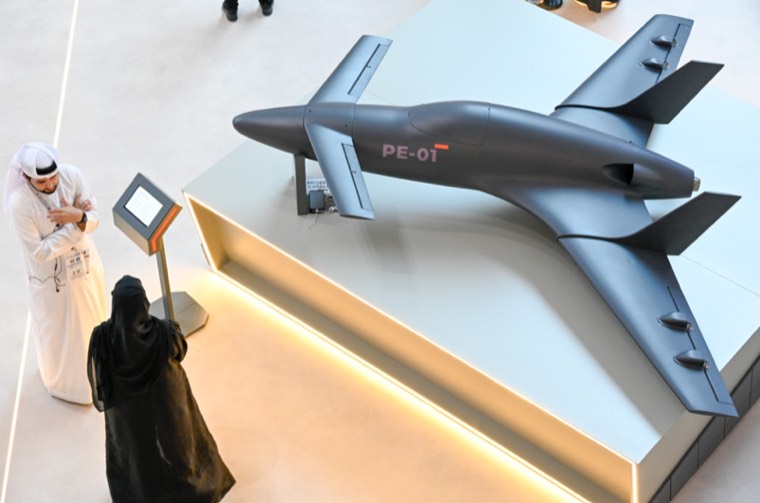 Visitors viewing unmanned aircraft arranged in an outdoor display